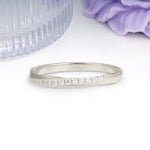 Soft Glossy Twisted Contour Half Way Channel Inlaid Tiny Gem Round Cut Moissanite Wedding Ring - Additional view