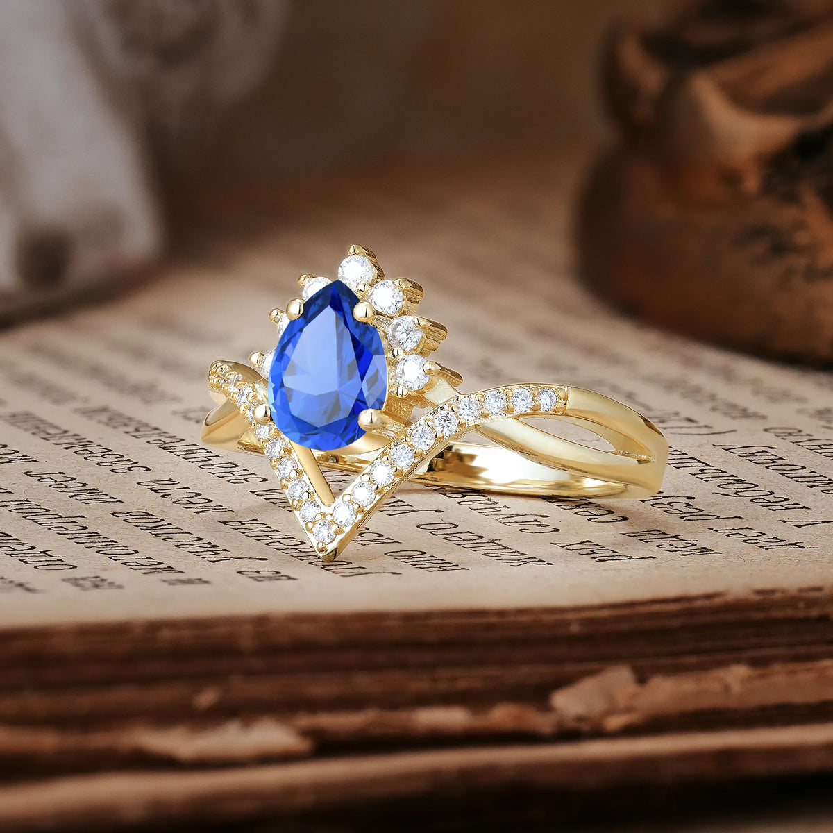 Princess Crown Pear Cut Halo V Shaped Twisted Pavé Shank Sapphire Engagement Ring