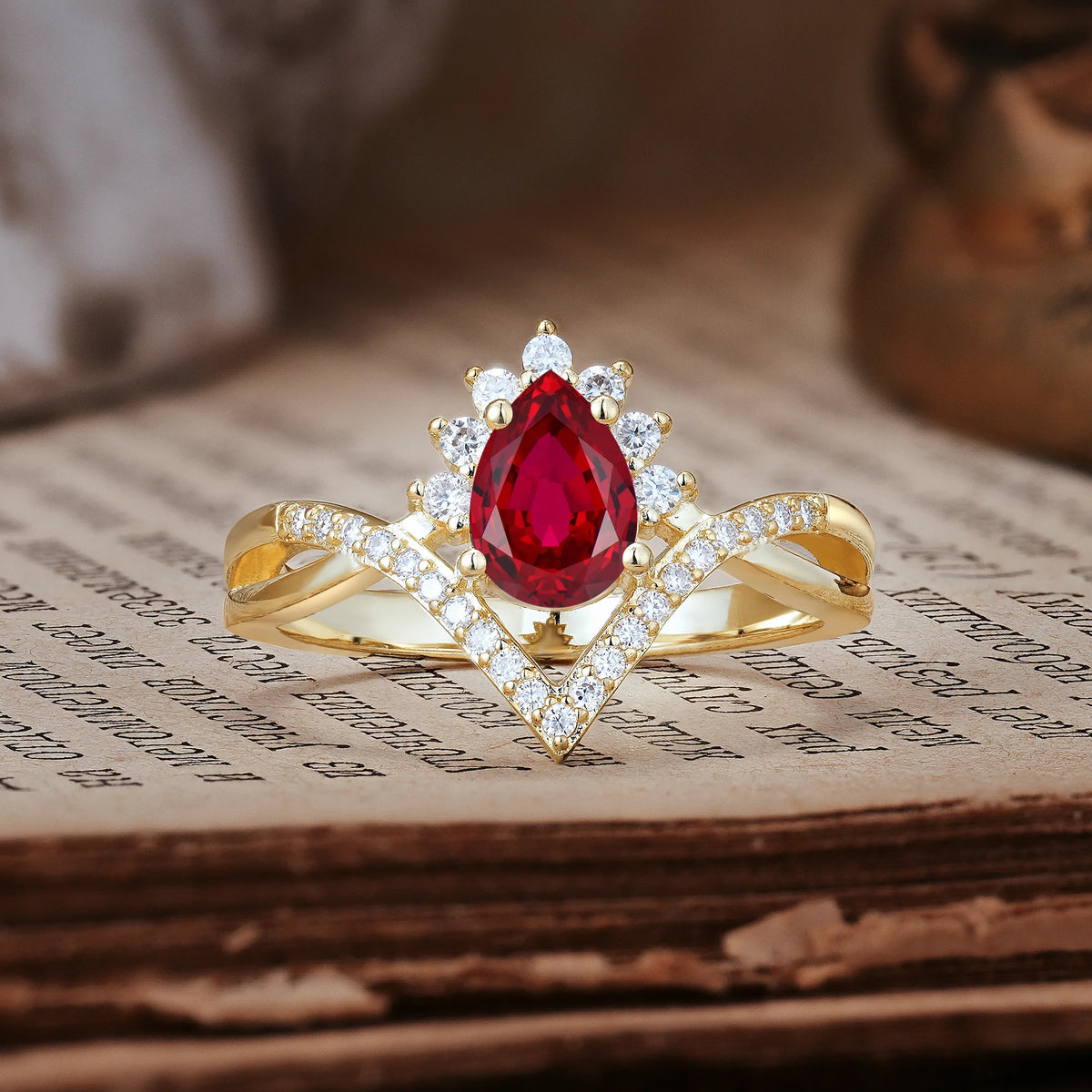 Princess Crown Pear Cut Halo V Shaped Twisted Pavé Shank Ruby Engagement Ring