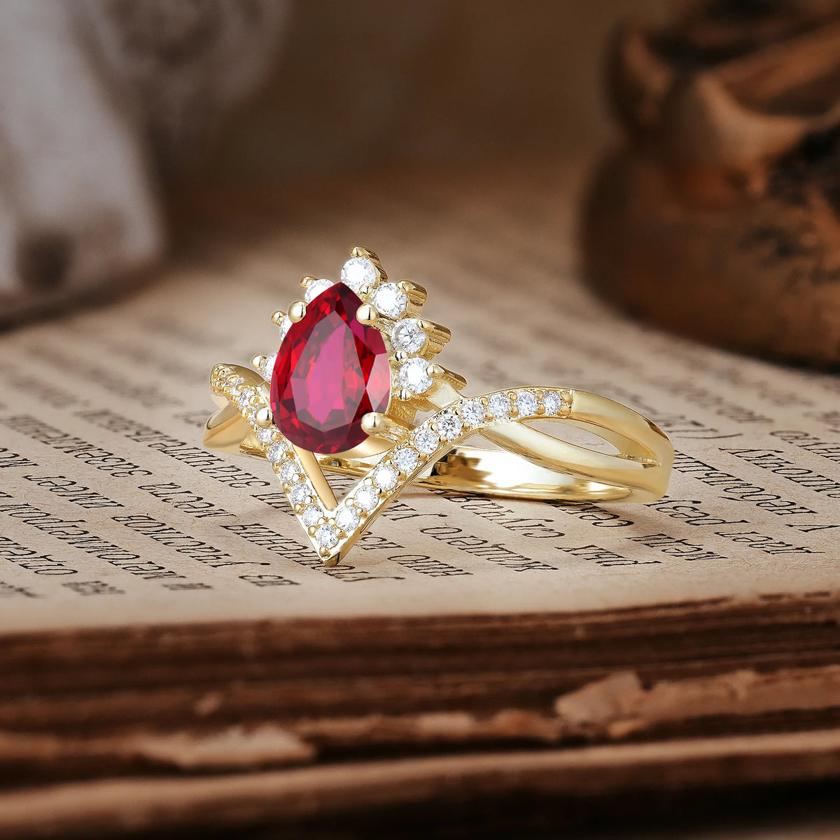 Princess Crown Pear Cut Halo V Shaped Twisted Pavé Shank Ruby Engagement Ring